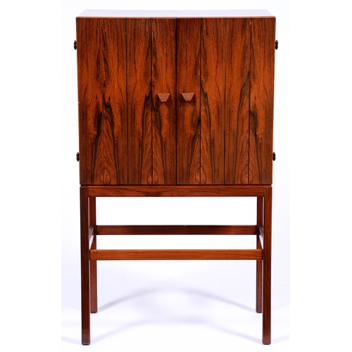 1358 - A rosewood cocktail cabinet, c1970,  with sycamore veneered interior the drawers with exposed c... 