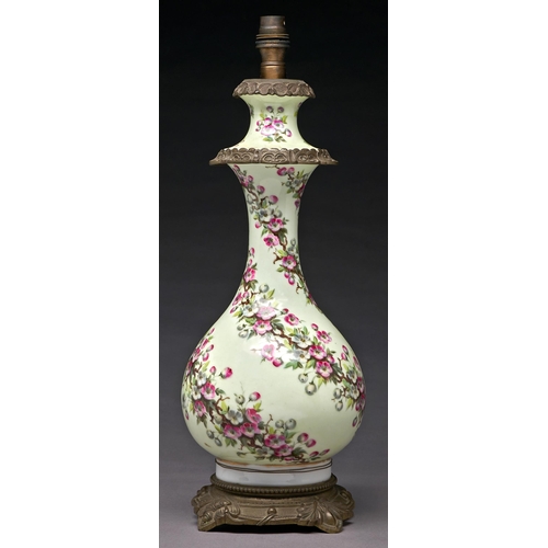 232 - A French gilt lacquered brass mounted porcelain oil lamp, c1880, of baluster shape, painted with spi... 