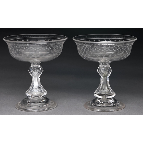 241 - A pair of Victorian glass sweetmeat stands, c1860, the bowl engraved with stars, on faceted baluster... 