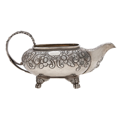 271 - A George III silver cream jug, with acanthus handle and chased with flowers, on four paw feet, 80mm ... 