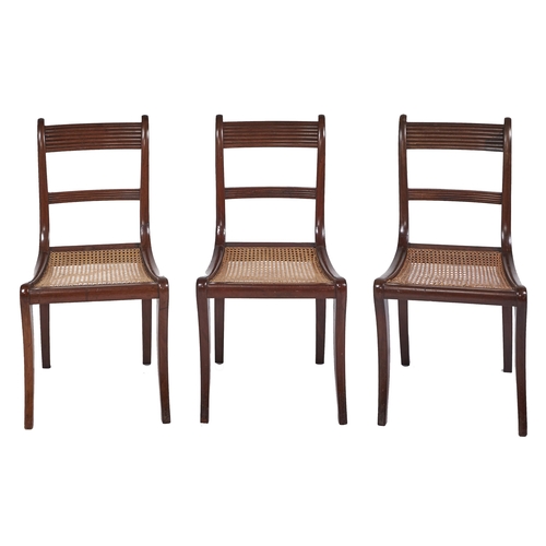 421 - A set of three George IV mahogany dining chairs, on sabre legs, caned seat, seat height 44cm... 