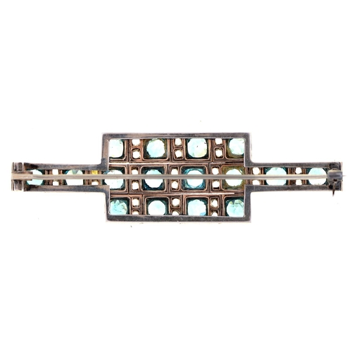 564 - A blue zircon and white stone brooch, c1930, adapted from a bracelet, mounted in white and gold colo... 