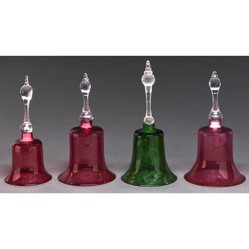 992 - Four Victorian cranberry or green glass ornamental bells, 29-33cm h