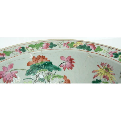 242 - A Chinese Canton famille rose bowl, mid 19th c, painted to the centre with a smiling man holding a s... 