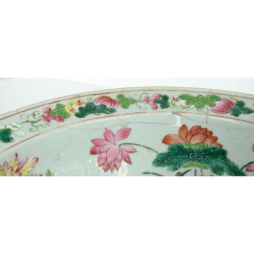 242 - A Chinese Canton famille rose bowl, mid 19th c, painted to the centre with a smiling man holding a s... 