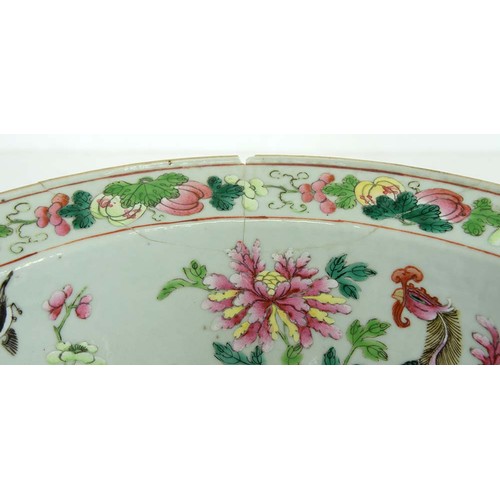 242 - A Chinese Canton famille rose bowl, mid 19th c, painted to the centre with a smiling man holding a s... 