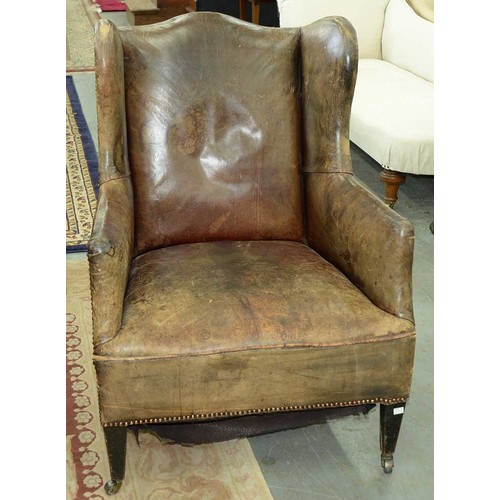 1325 - An Edwardian wingback armchair, c1905, the serpentine back, wings and stuffed over seat upholstered ... 