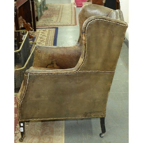 1325 - An Edwardian wingback armchair, c1905, the serpentine back, wings and stuffed over seat upholstered ... 