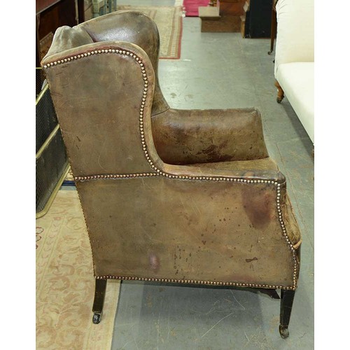 1325 - An Edwardian wingback armchair, c1905, the serpentine back, wings and stuffed over seat upholstered ... 