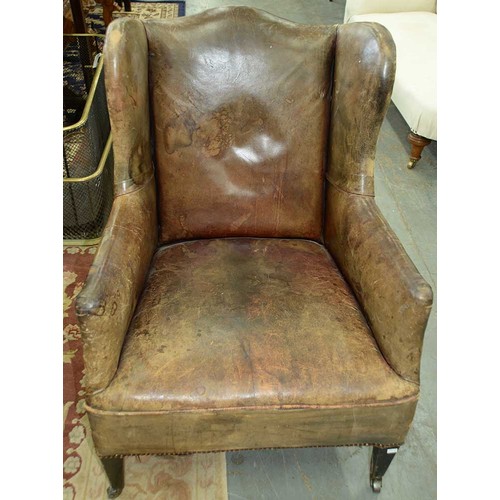 1325 - An Edwardian wingback armchair, c1905, the serpentine back, wings and stuffed over seat upholstered ... 