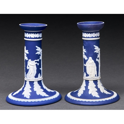 297 - A pair of William Adams & Co dark blue jasper dip candlesticks, c1900, sprigged with classical f... 