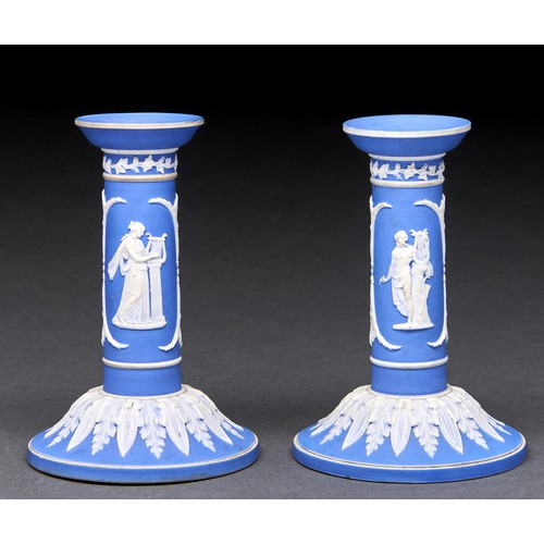 297 - A pair of William Adams & Co dark blue jasper dip candlesticks, c1900, sprigged with classical f... 