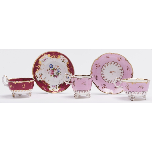 100 - An H & R Daniel claret ground teacup and saucer and pink ground trio, c1827, of C-scroll shape, ... 
