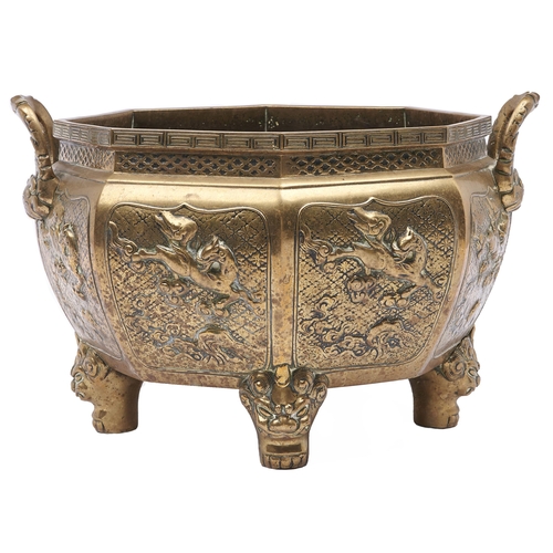 448 - A Japanese two handled octagonal bronze vessel, Meiji period,  on four shi-shi feet, 25cm h... 