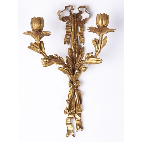 483 - An ormolu twin light wall sconce, 20th c, in Louis XVI style, of leafy scrolling floriform design wi... 