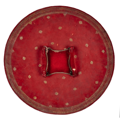 512 - An Indian lacquered hide shield, dhal, 19th c, of slightly convex form, the central red tooled round... 