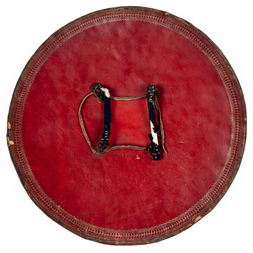 513 - An Indian lacquered hide shield, dhal, 19th c, of slightly convex form, the central red tooled round... 