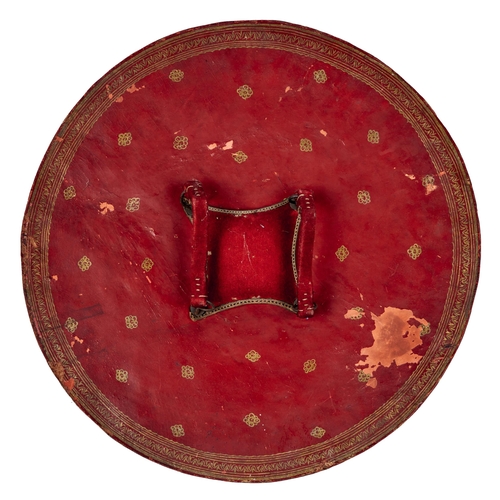 514 - An Indian lacquered hide shield, dhal, 19th c, of richly convex form, the central red tooled roundel... 