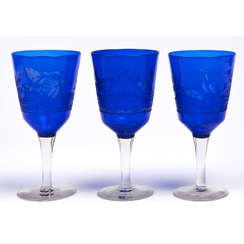 61 - Cockfighting. A set of three wheel engraved glass goblets, first half 20th c, the bowl cased in blue... 