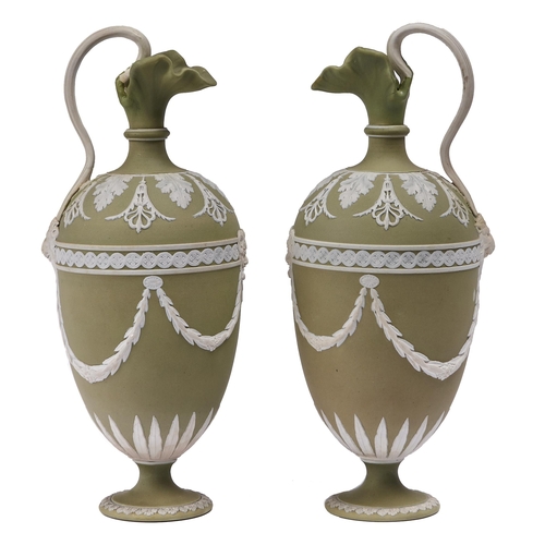 75 - A pair of Wedgwood green Jasper ewers, late 19th c, ornamented with festoons and satyr masks, 23cm h... 