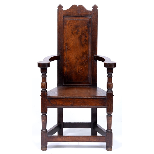 802 - An oak panel back armchair, early 20th c,  in 17th c English style, the back with raised and fi... 