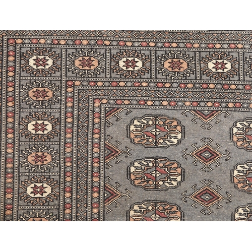 875 - A blue ground Bokhara pattern rug, 188 x 275cm