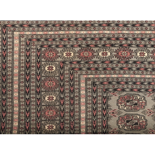 876 - A blue ground Bokhara design rug, 290 x 365cm