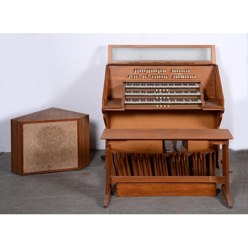 936 - An oak three manual electronic organ, circa mid 20th c, 130cm l, with oak stool and a loudspeaker... 