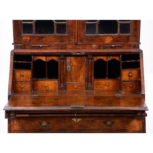 941 - A George II walnut and feather banded bureau-cabinet, with cavetto cornice and fitted with adjustabl... 