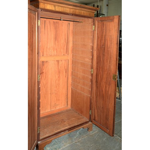 940 - A mahogany wardrobe, early 20th c, with dentil cornice and fitted for trays or other, enclosed by a ... 