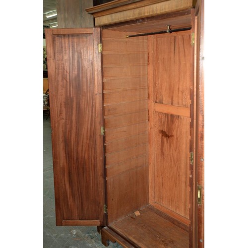 940 - A mahogany wardrobe, early 20th c, with dentil cornice and fitted for trays or other, enclosed by a ... 