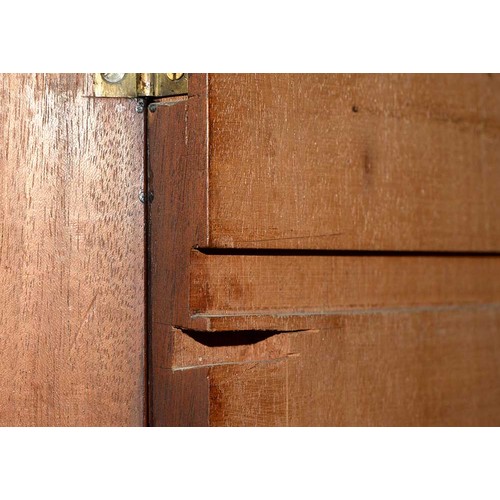 940 - A mahogany wardrobe, early 20th c, with dentil cornice and fitted for trays or other, enclosed by a ... 