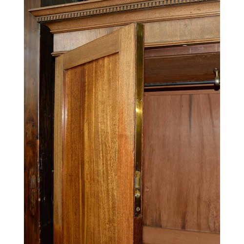 940 - A mahogany wardrobe, early 20th c, with dentil cornice and fitted for trays or other, enclosed by a ... 