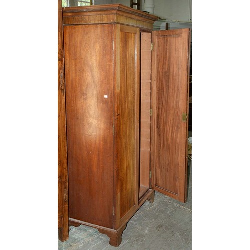 940 - A mahogany wardrobe, early 20th c, with dentil cornice and fitted for trays or other, enclosed by a ... 