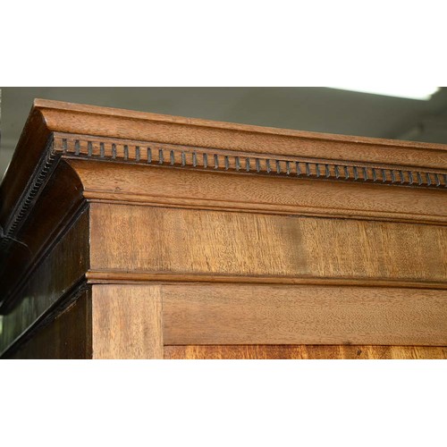 940 - A mahogany wardrobe, early 20th c, with dentil cornice and fitted for trays or other, enclosed by a ... 