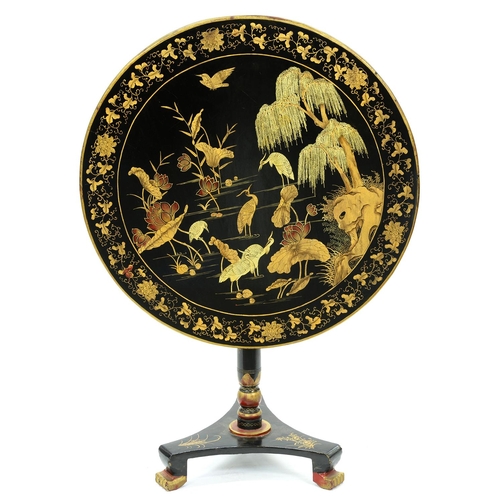 1245 - A Chinese black and gold export lacquer pedestal table, 19th c, the round top decorated with birds i... 