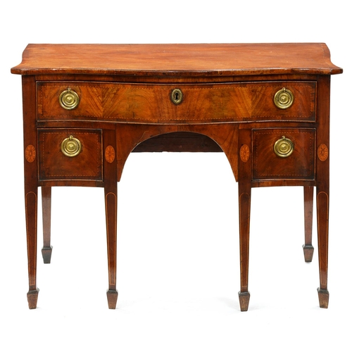 1246 - A George III serpentine mahogany dressing table, with broken line inlay and oval paterae, the drawer... 