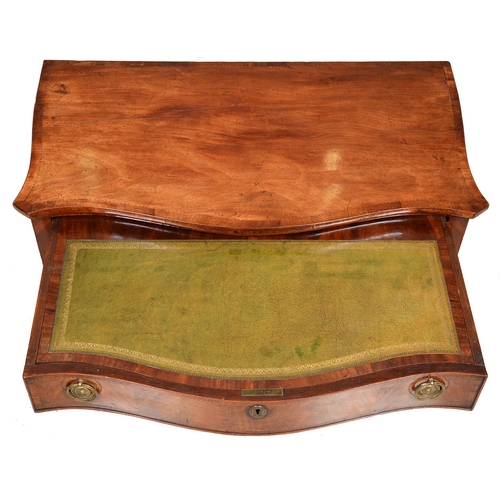 1246 - A George III serpentine mahogany dressing table, with broken line inlay and oval paterae, the drawer... 