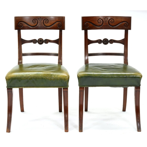 1247 - A pair of William IV mahogany dining chairs, the curved top rail carved with two S-scrolls above ros... 