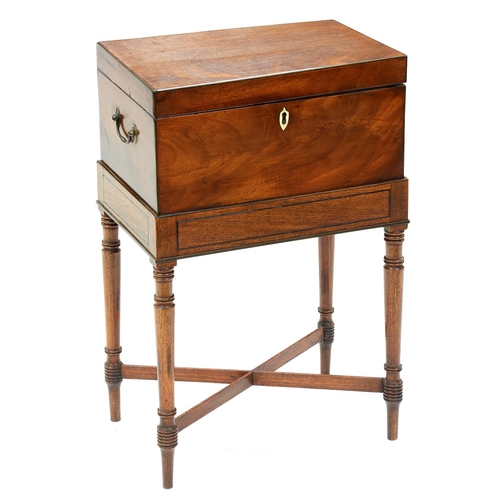 1259 - A George III mahogany teapoy, the affixed line inlaid stand on ring turned legs, crossed stretchers,... 