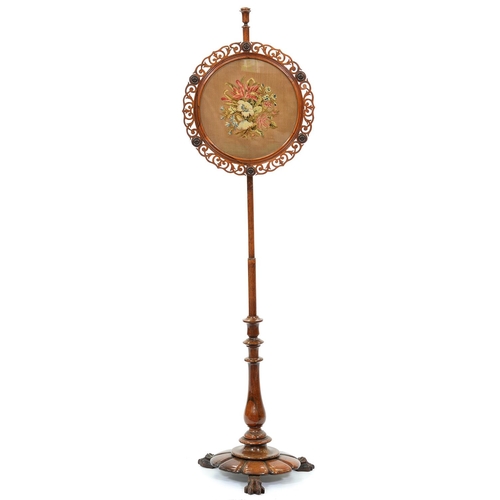 1278 - A Victorian rosewood pole screen, c1840,  with  floral gros point banner  within a fret cut frame wi... 