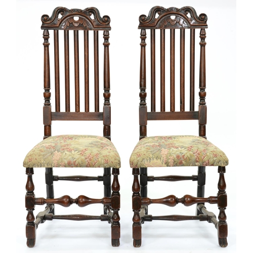 1300 - A pair of George I walnut chairs, the breakarched top rail crested by S-scrolls, the back with plain... 