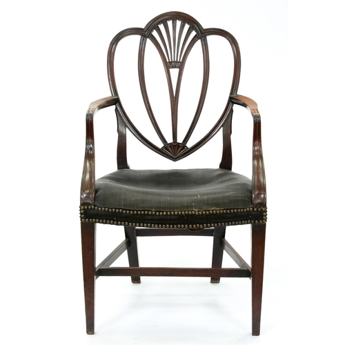 1302 - A George III mahogany elbow chair in the manner of Gillows, with fluted, heart shaped back and mould... 