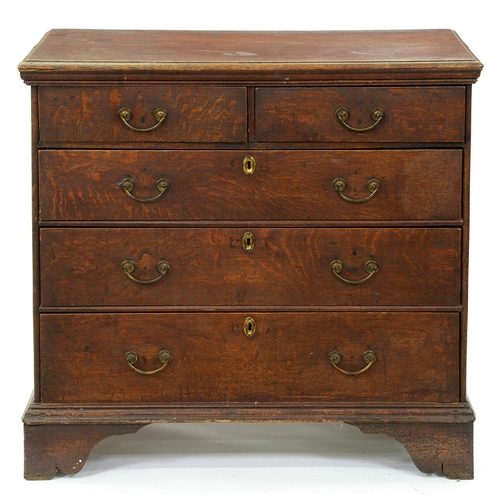 1307 - A George III oak chest of drawers, c1780, the rectangular top with moulded lip above two short over ... 