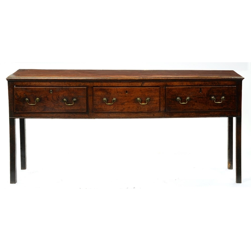 1310 - A George III elm dresser,  with moulded lip above three short drawers,   brass  loop handles,  on sq... 