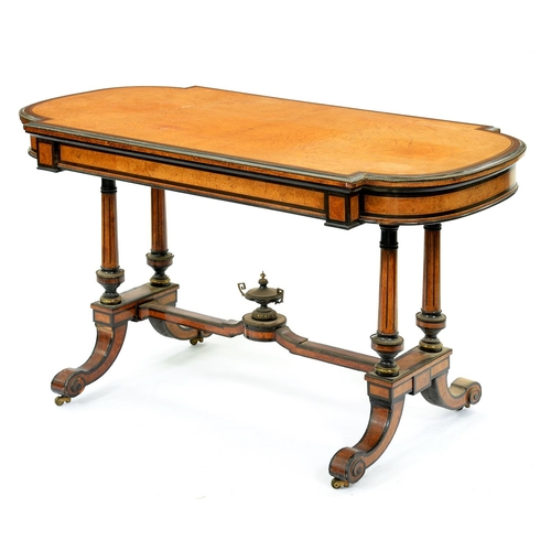 1323 - A Victorian amboyna and ebonised mahogany writing table, the bow ended quarter veneered top fitted w... 