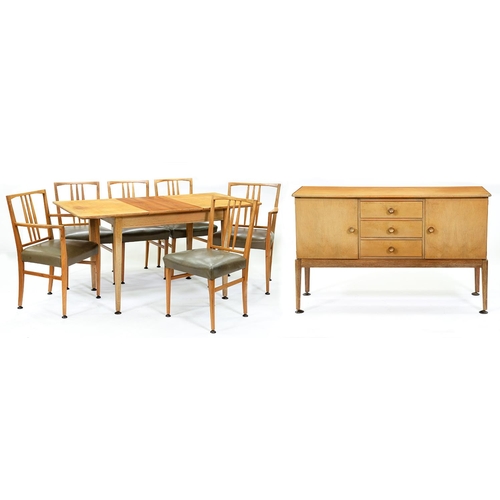 1337 - Gordon Russell.  A mid century walnut dining suite, comprising extending table,  six chairs includin... 