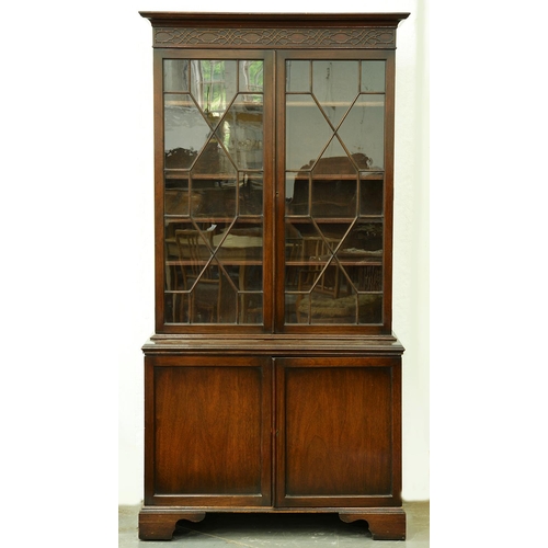 1345 - A mahogany bookcase, early 20th c,  the upper part with cavetto cornice and blind fret carved frieze... 