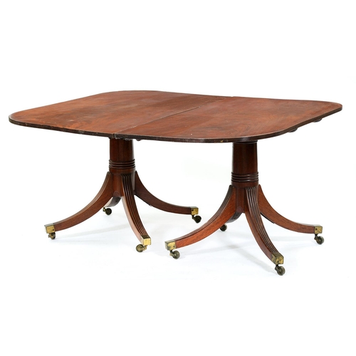 1349 - A George III twin-pillar mahogany dining table, the finely figured top on ring turned 'gun barrel' p... 