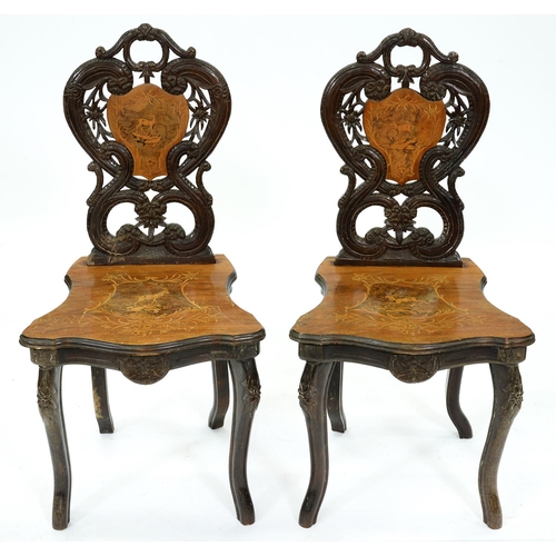 1359 - A pair of Swiss carved, stained and inlaid walnut chairs, late 19th c, the seat and back decorated i... 